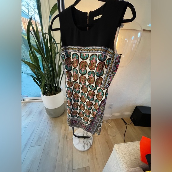 Above the knee dress, skirt has a faux wrap opening, zipper closure in back. - Picture 1 of 4